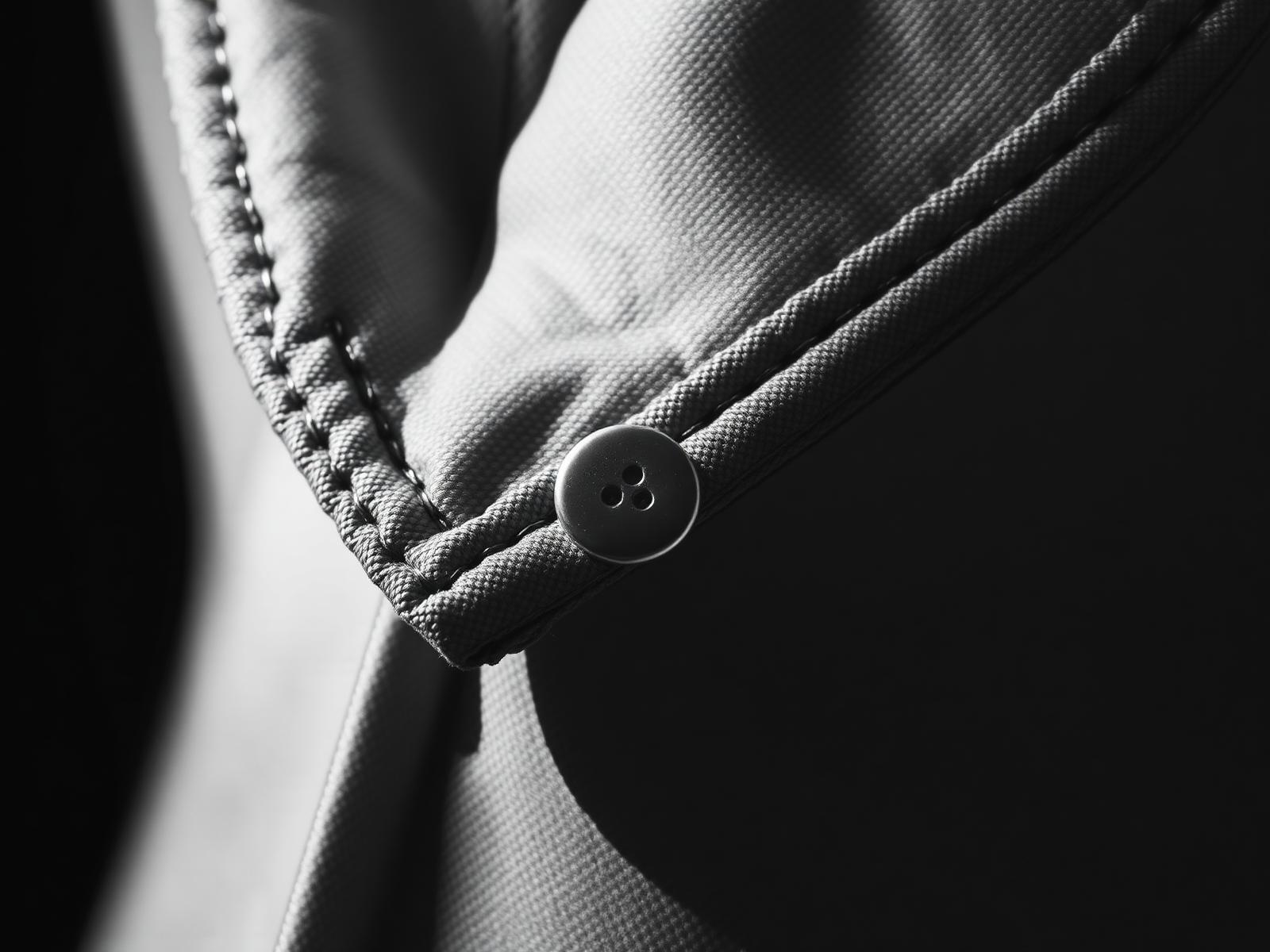 Macro detail of collar stitching and a bone button